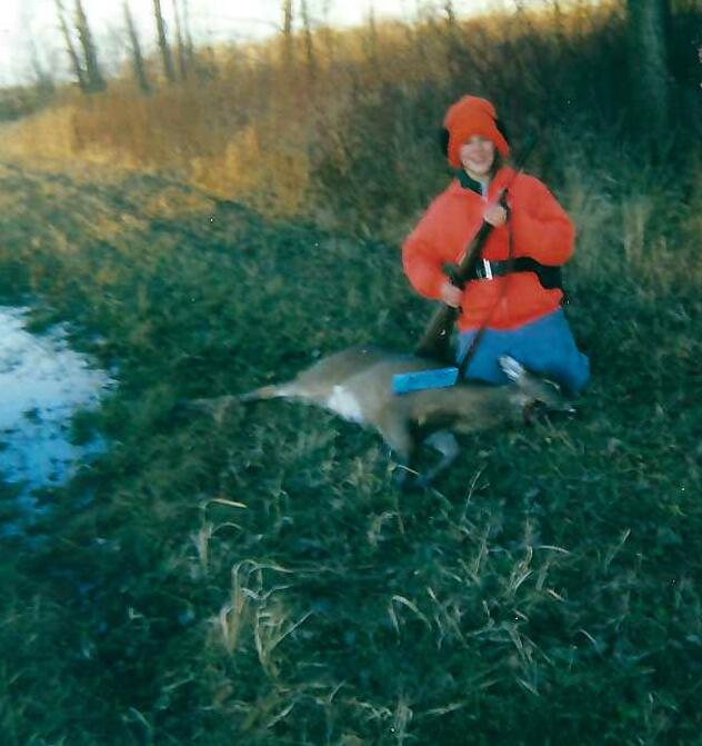Hicks, Hoodlums, & Highrises author, Nicole Braun, in blaze orange with her first deer
