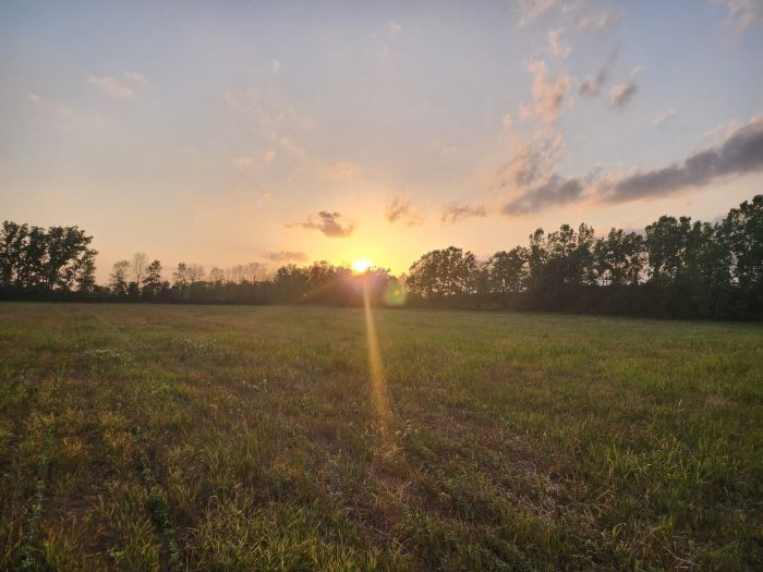 Sunsets over a beautiful hay field
