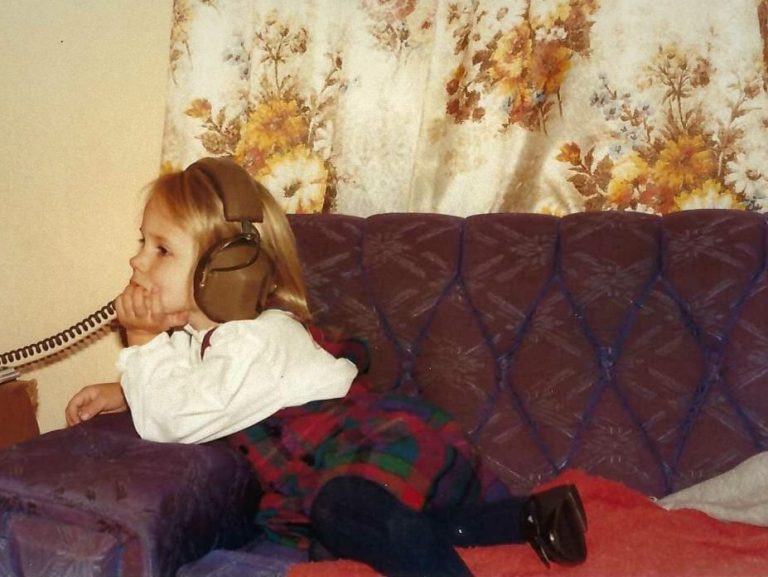 Hicks, Hoodlums, & Highrises author, Nicole Braun, listens to stories on her grandfather's couch as a small child